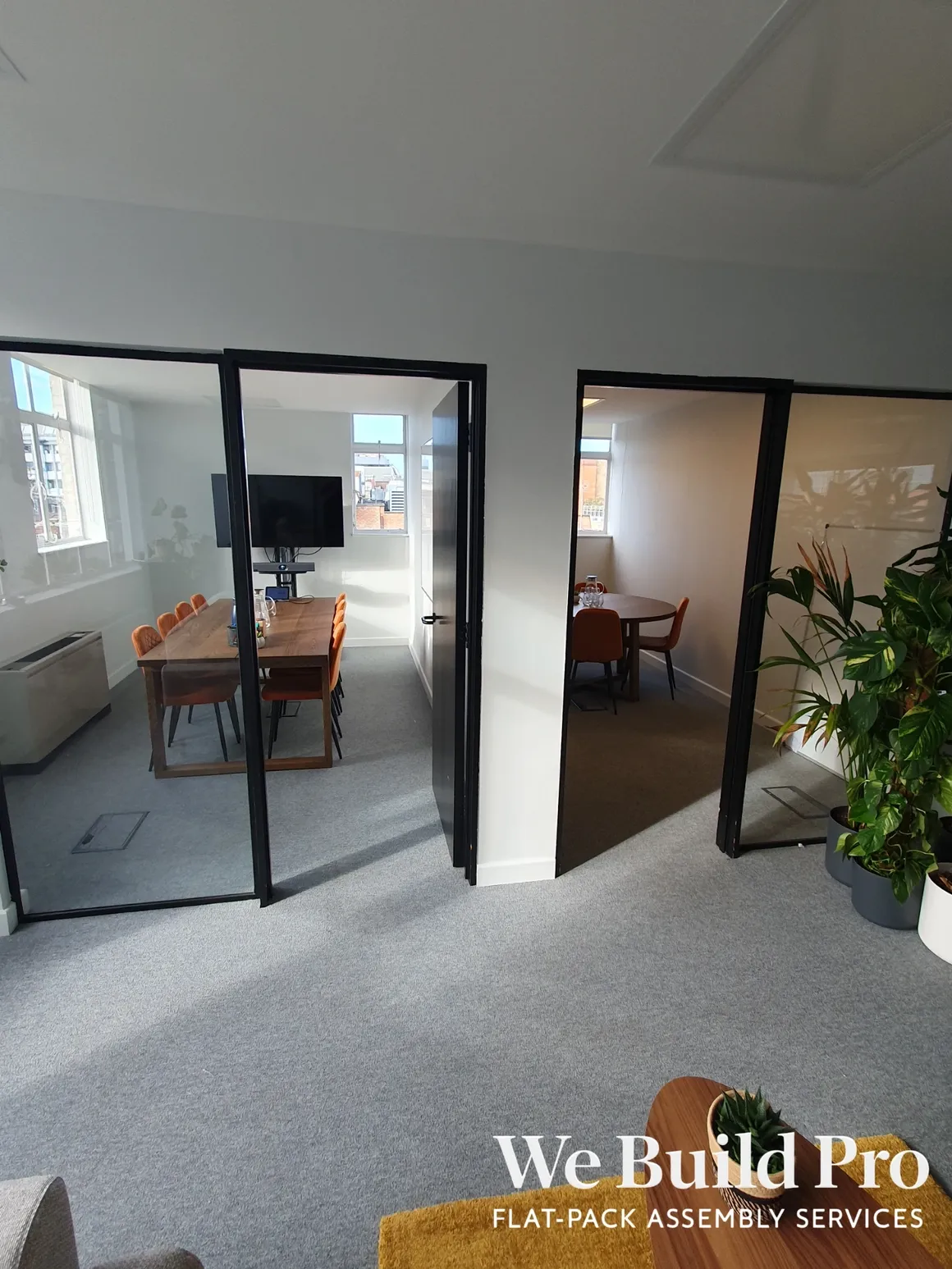 Modern office space with glass partitions and meeting rooms