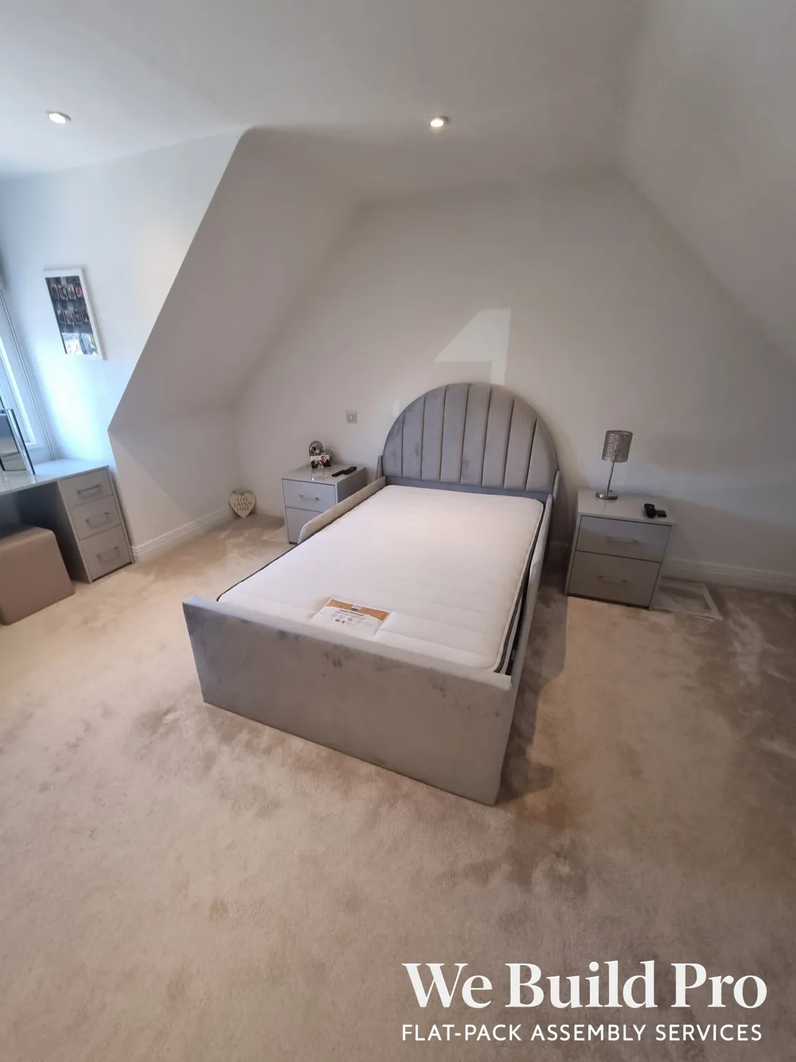Modern bedroom with grey upholstered bed and matching nightstands