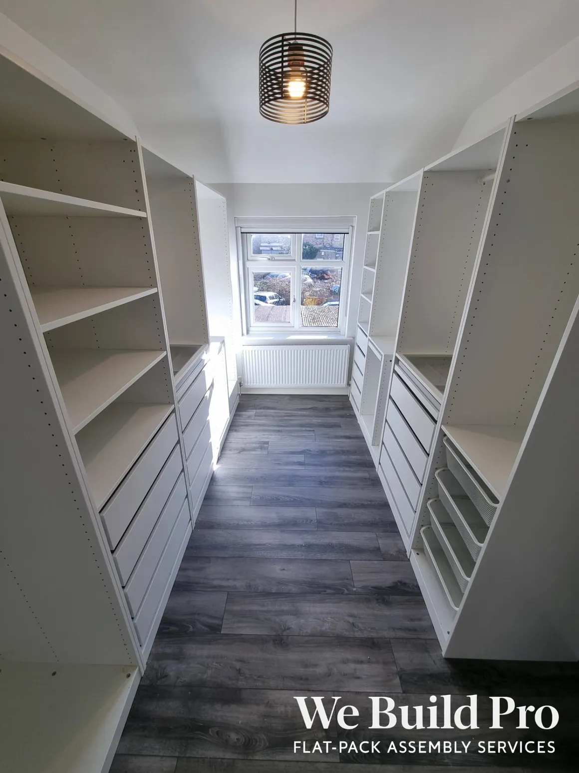 White walk-in closet system with organized shelving and drawers