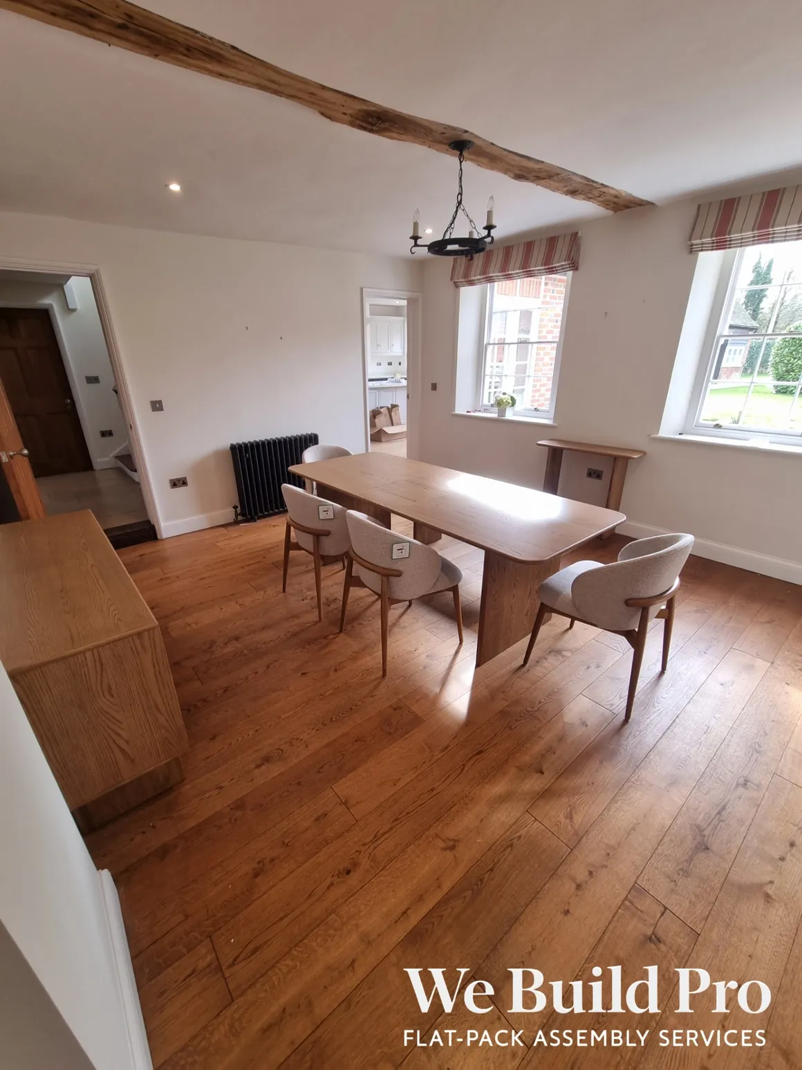 Traditional dining room with wooden table, chairs, and exposed beam ceiling